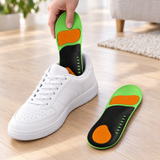Arch support insole being placed into a white sneaker