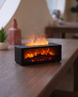 Flame aroma diffuser with fireplace effect on a table